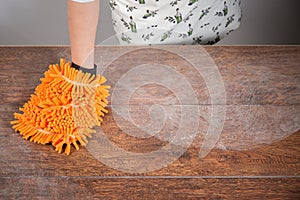 Woman cleaning dusty table