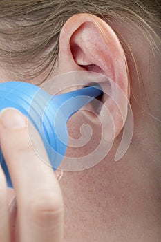 Woman cleaning ear with bulb syringe