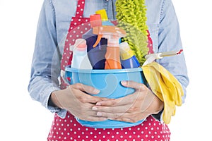 Woman with cleaning equipment ready to clean house