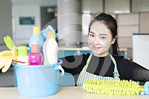 Woman with cleaning equipment ready to clean house or office
