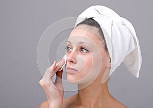 Woman cleaning face
