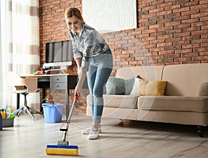 Woman cleaning floor with mop