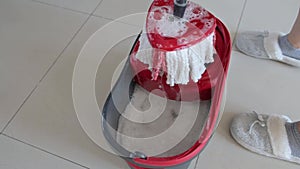 Woman Cleaning Floor with Mop