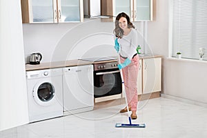 Woman Cleaning Floor With Mop photo