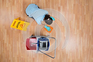 Woman Cleaning Floor With Rag