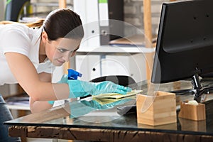 Woman Cleaning The Glass Office Desk