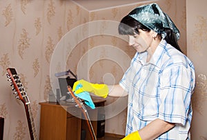 Woman cleaning a guitar with a rag