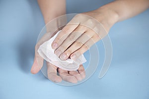 Woman cleaning hand in napkin