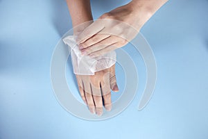 Woman cleaning hands in napkin