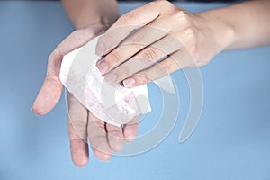 Woman cleaning hands in napkin