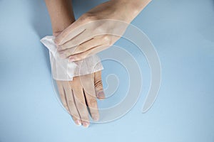 Woman cleaning hands in napkin