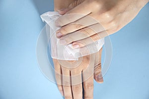 Woman cleaning hands with a napkin