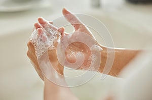 Woman, cleaning and hands with soap, bubbles or water in bathroom for hygiene, healthcare or safety. Hand washing, foam