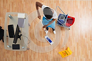 Woman Cleaning Hardwood Floor With Mop