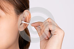 Woman cleaning her ear with a cotton swab. A woman suffered an infection after using the sticks incorrectly