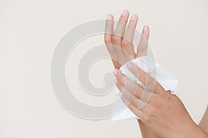 Woman cleaning her hands with a tissue.