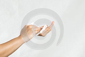 Woman cleaning her hands with white soft tissue paper. isolated on a white backgrounds