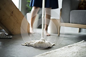 Woman cleaning home with mop photo