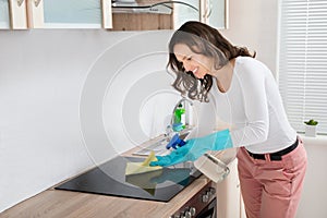 Woman Cleaning Induction Hob