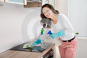 Woman Cleaning Induction Hob photo