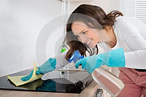 Woman Cleaning Induction Hob photo