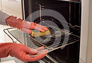 Woman cleaning oven