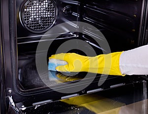 Woman cleaning oven