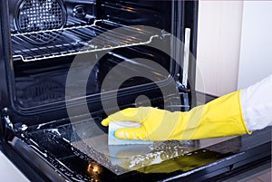 Woman cleaning oven photo