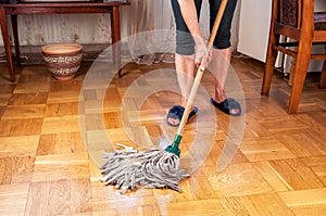 Woman cleaning parquet
