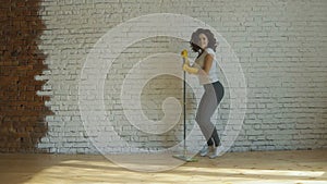 Woman cleaning parquet floors in the living room. Close-up.
