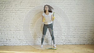 Woman cleaning parquet floors in the living room. Close-up.