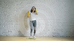 Woman cleaning parquet floors in the living room. Close-up.