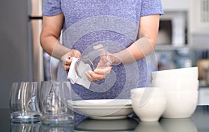 Woman Cleaning product concept wiping dishware cleaner in home a