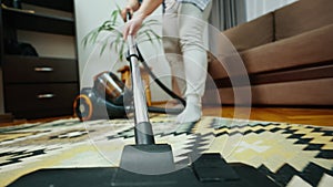 Woman cleaning the room with a vacuum cleaner.