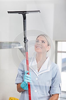 Woman cleaning with rubber window cleaner
