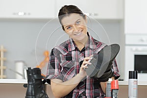 Woman cleaning shoes with brush