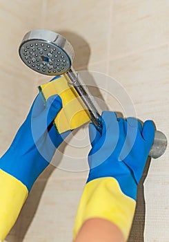 Woman cleaning shower.