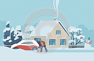 Woman cleaning snow with shovel around her country house. Wintertime work at yard or road. Winter scene at snowy weather