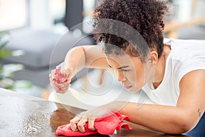 Woman, cleaning and spray for counter in home, maid and chemical disinfection for hygiene. Female person, dust and