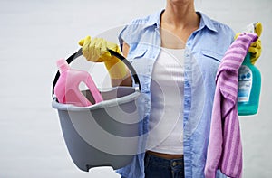 Woman, cleaning and supplies for housekeeping in home, bleach and detergent for sanitation or disinfection. Female