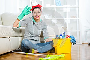 Woman with cleaning supplies in the living room