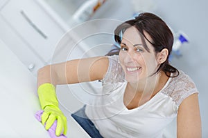 woman cleaning surface in kitchen