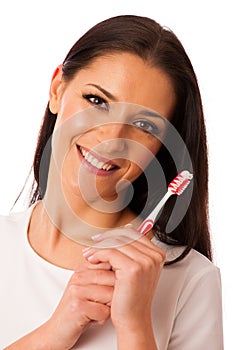Woman cleaning teeth with toothbrush for perfect hygiene and healthy teeth.