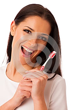 Woman cleaning teeth with toothbrush for perfect hygiene and healthy teeth.