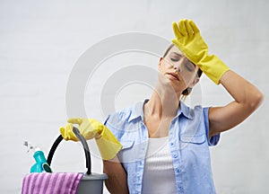 Woman, cleaning and tired for housekeeping in home, bleach and detergent for sanitation or disinfection. Female person