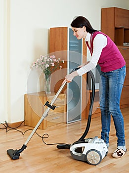 Woman cleaning with vacuum cleaner