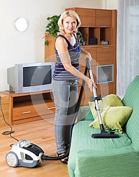 Woman cleaning with vacuum cleaner