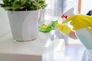 Woman cleaning white shelf