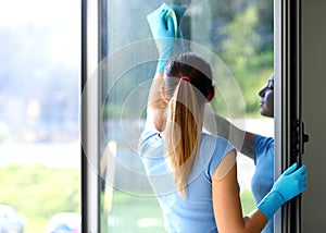 Woman cleaning windows at home