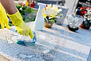 A woman cleans the grave.